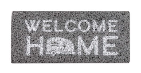 A welcome home mat with an rv on it.