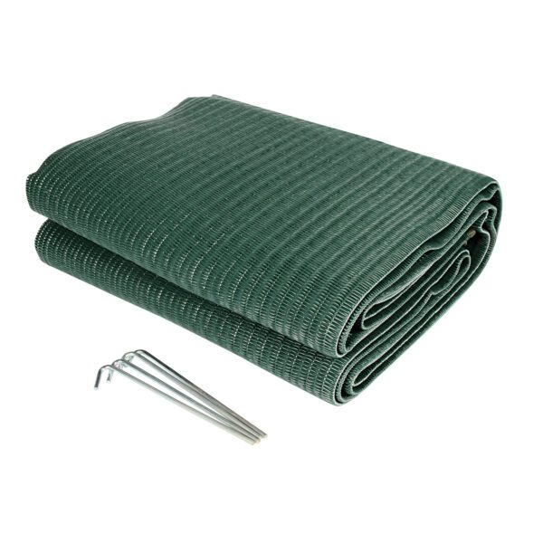 A blanket and a pin are laying on the ground.